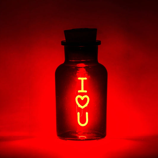 Glass bottle with 'I heart U' text on a red background