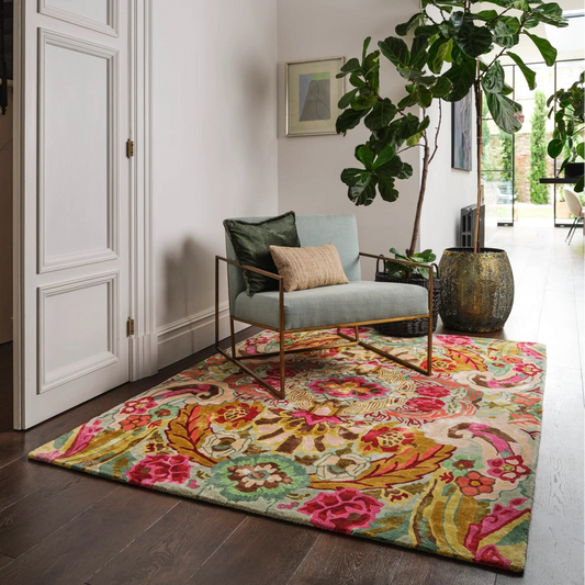 Colorful floral rug on a wooden floor with a chair and decorative elements.