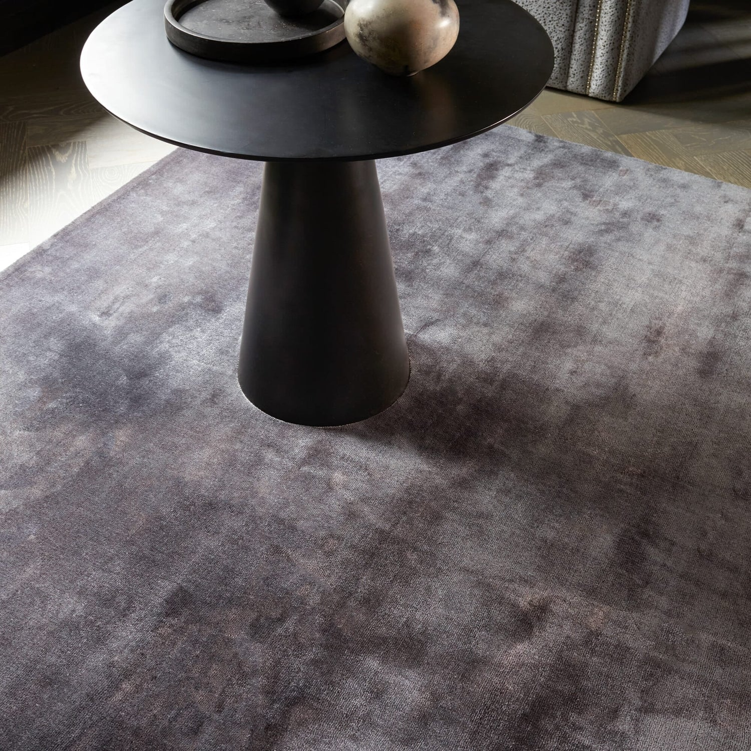 Black side table on a gray rug