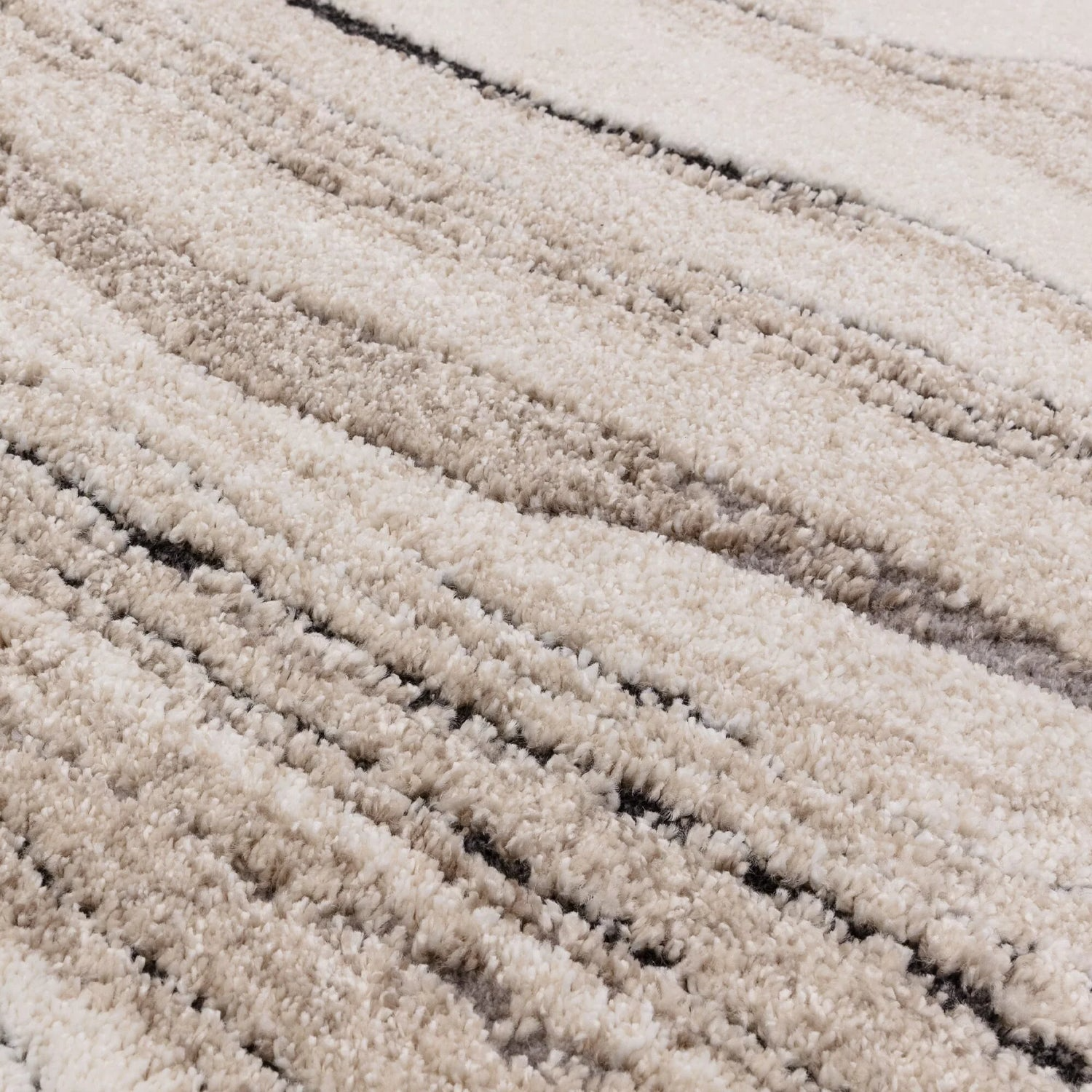 Close-up of a textured beige carpet with wavy pattern