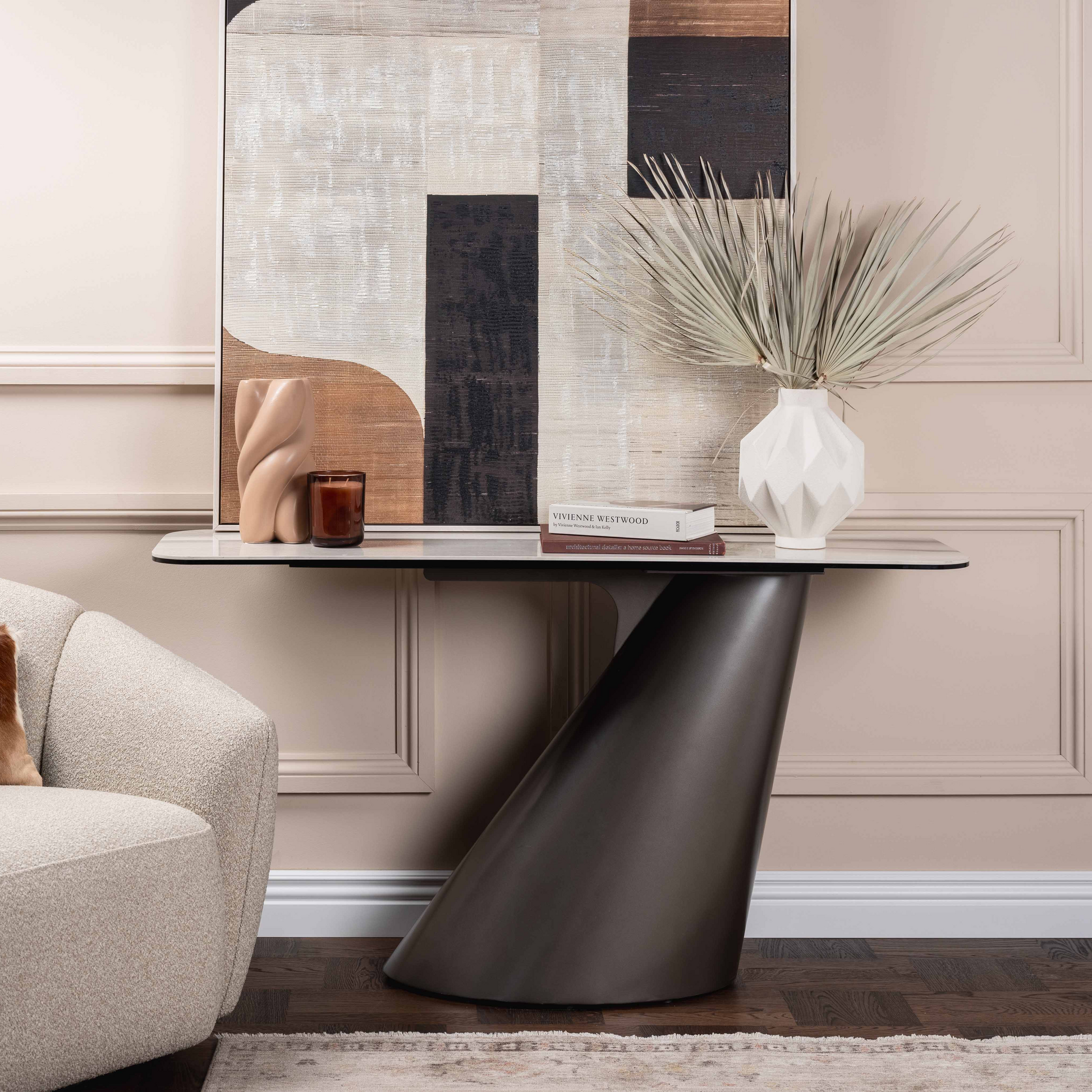 Modern living room with a stylish armchair, console table, and abstract wall art.