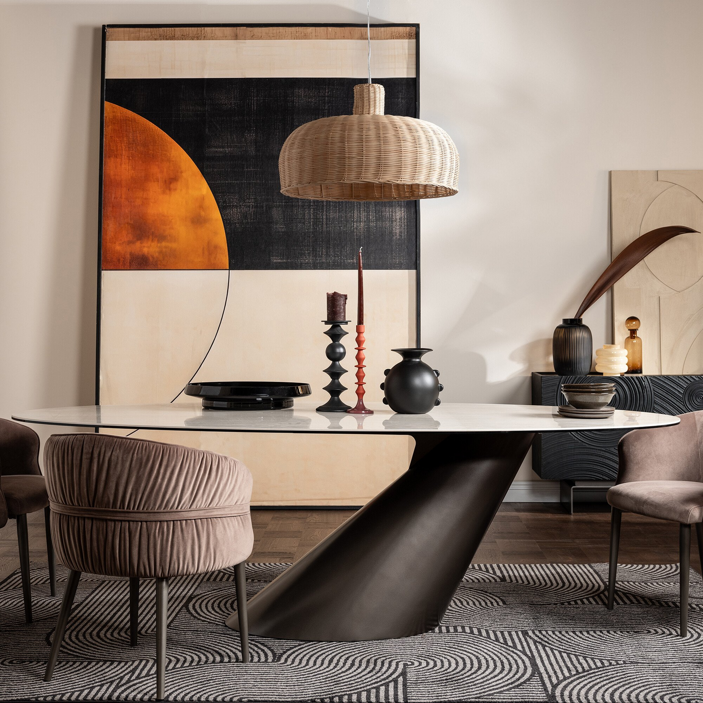 Modern dining room with a large abstract painting, pendant light, and decorative items on a table.