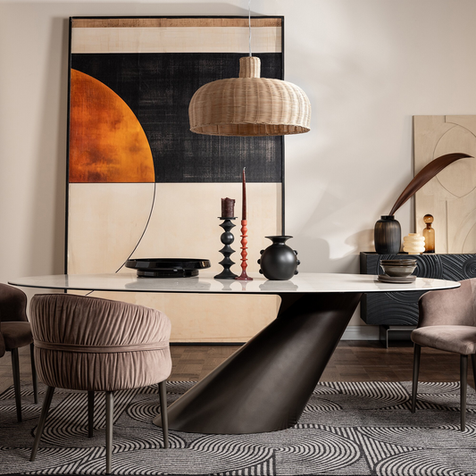 Modern dining room with a large abstract painting, pendant light, and decorative items on a table.
