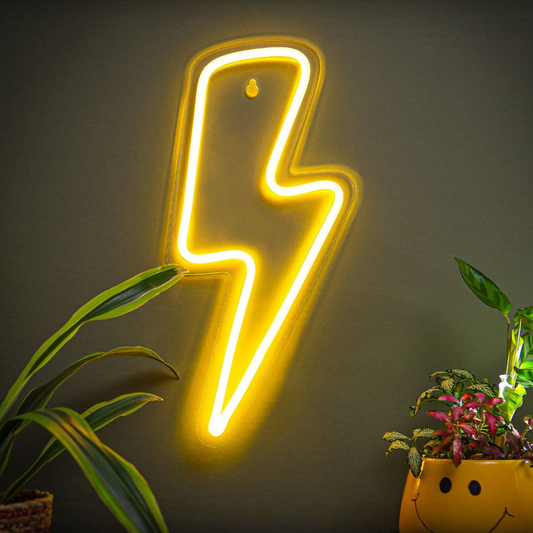 Neon lightning bolt sign on a dark wall with plants