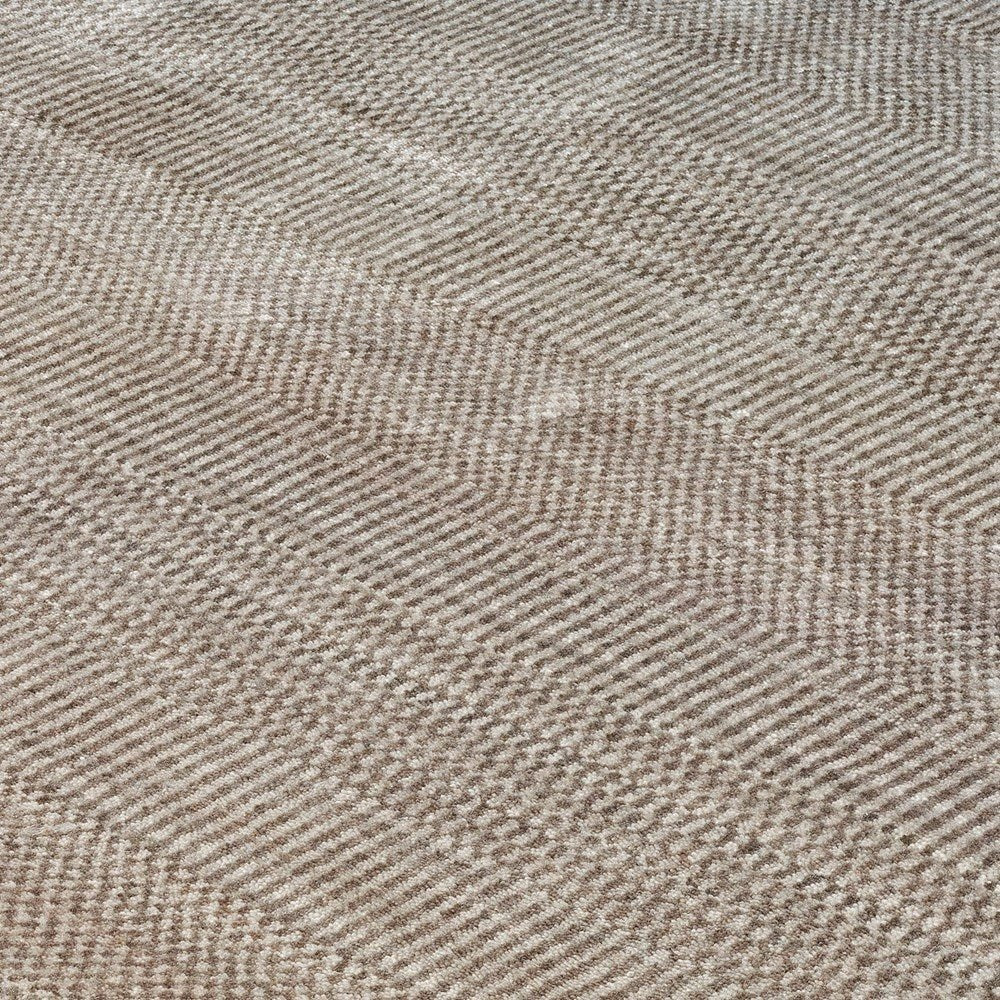 Close-up of a textured beige rug with a subtle pattern
