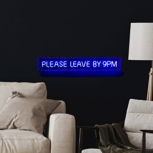 This image displays a sleek, modern LED sign with the phrase "Please Leave By 9pm" illuminated in a vivid blue hue. The sign is mounted on a wall in a stylish living room setting, featuring a minimalist design that enhances its visual appeal.