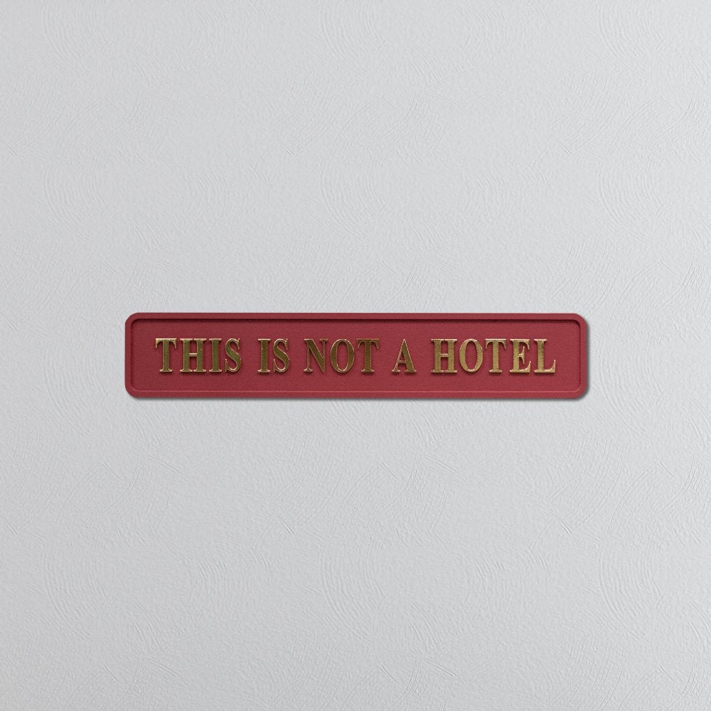 Red and Gold 'This Is Not A Hotel' Sign