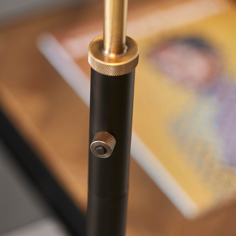 Close-up of a black and gold cylindrical object on a blurred background