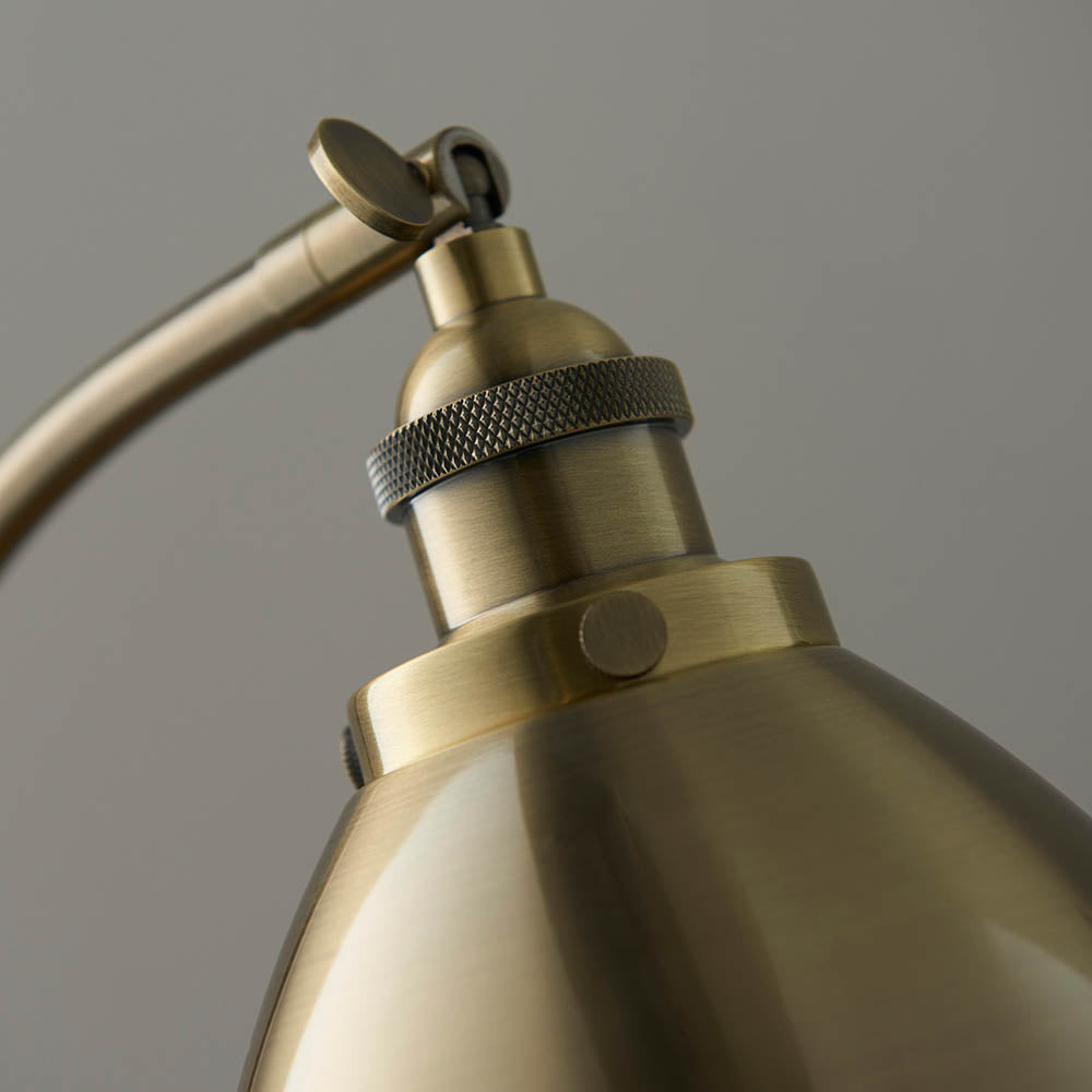 Close-up of a brass lamp with a gray background