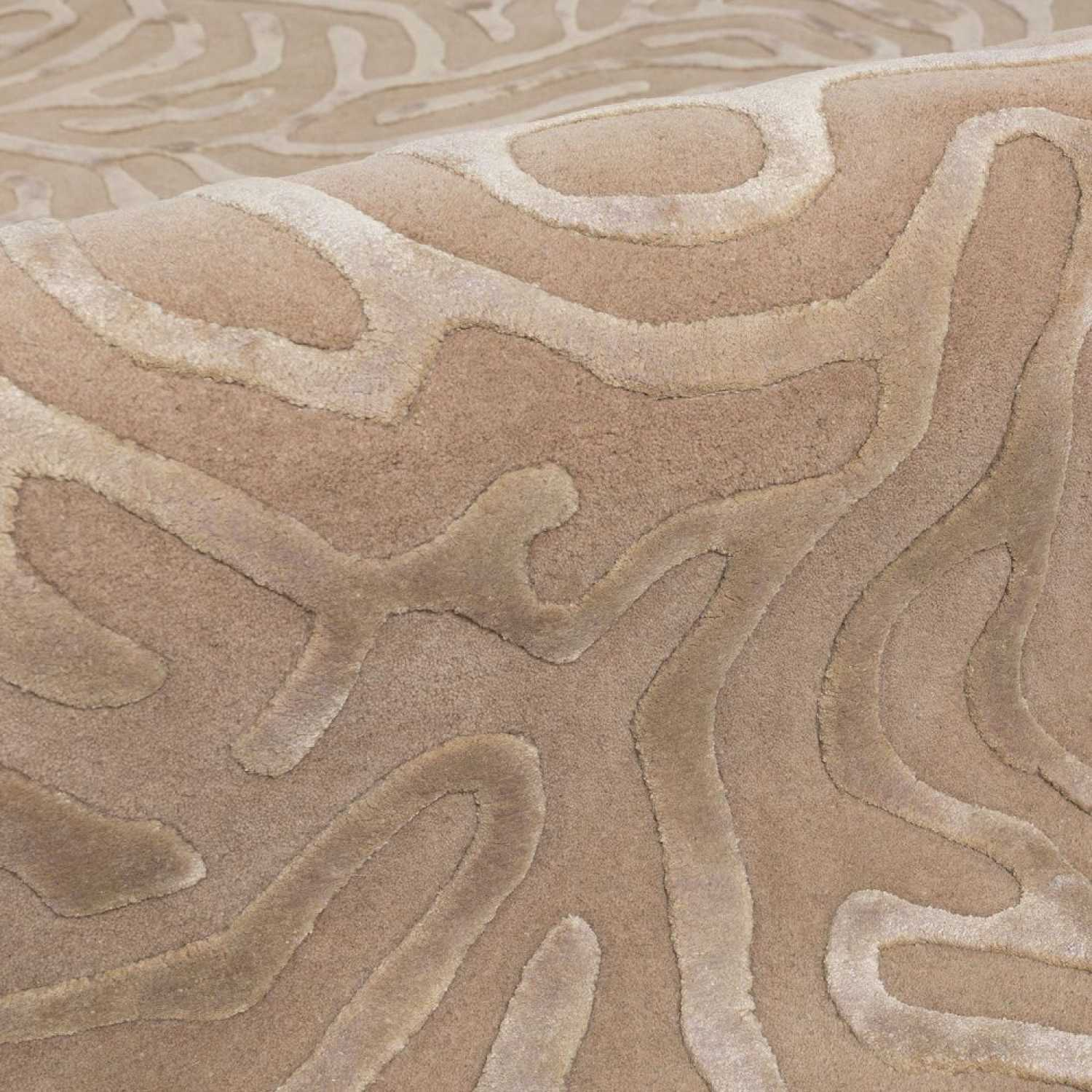 Close-up of a textured beige carpet with wavy pattern