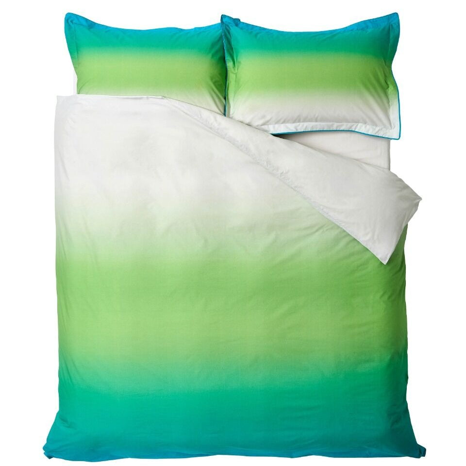 Green and blue gradient bedding set with matching pillows on a white background