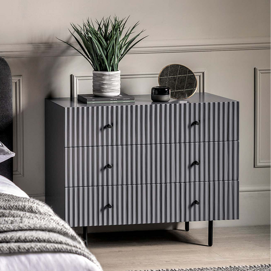 Gray dresser with decorative items in a bedroom setting