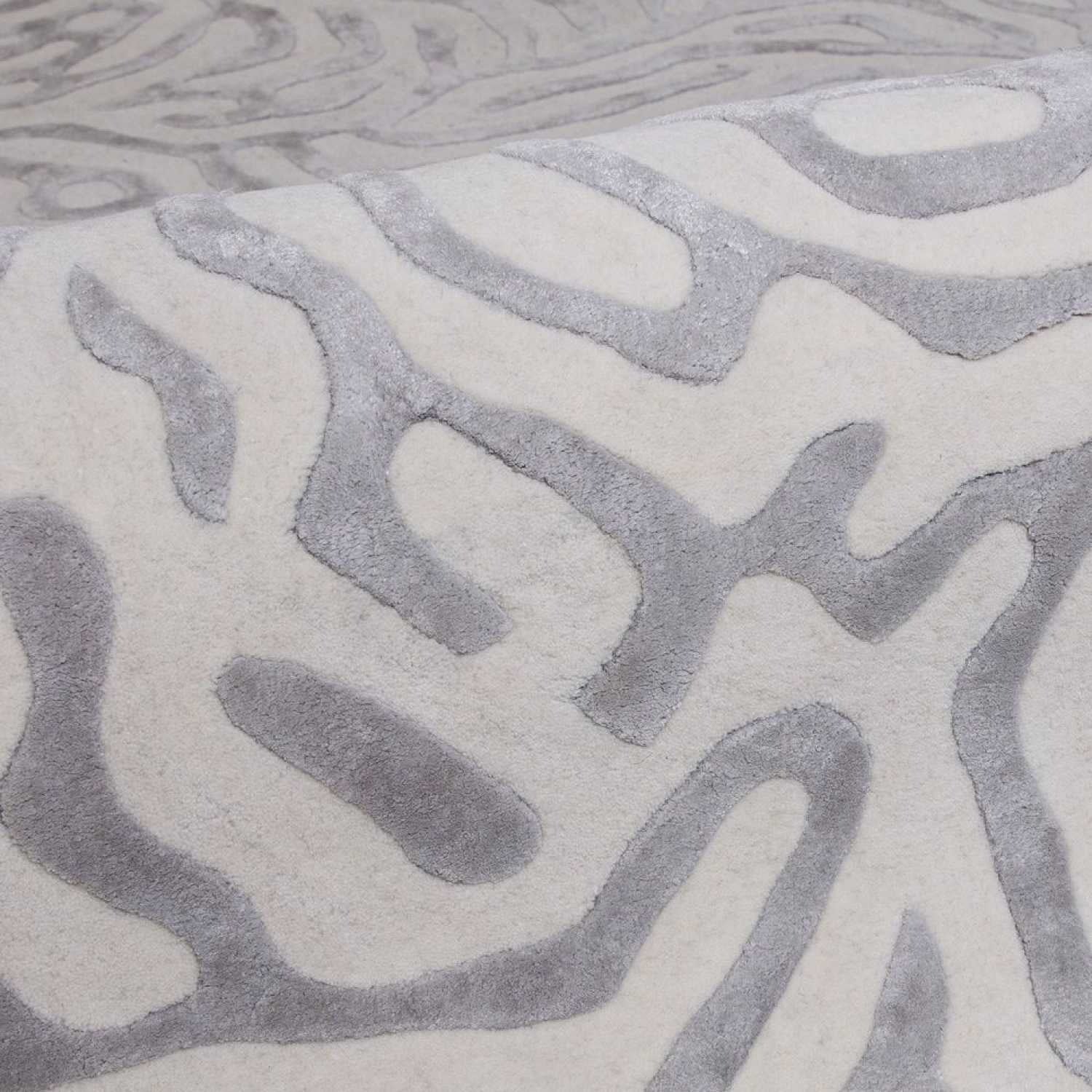 Close-up of a textured gray and white patterned rug