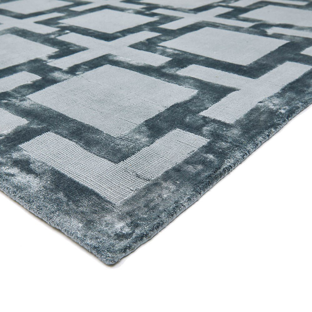 blue geometric patterned rug on a white background