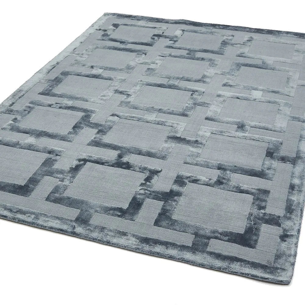 blue area rug with geometric pattern on a white background