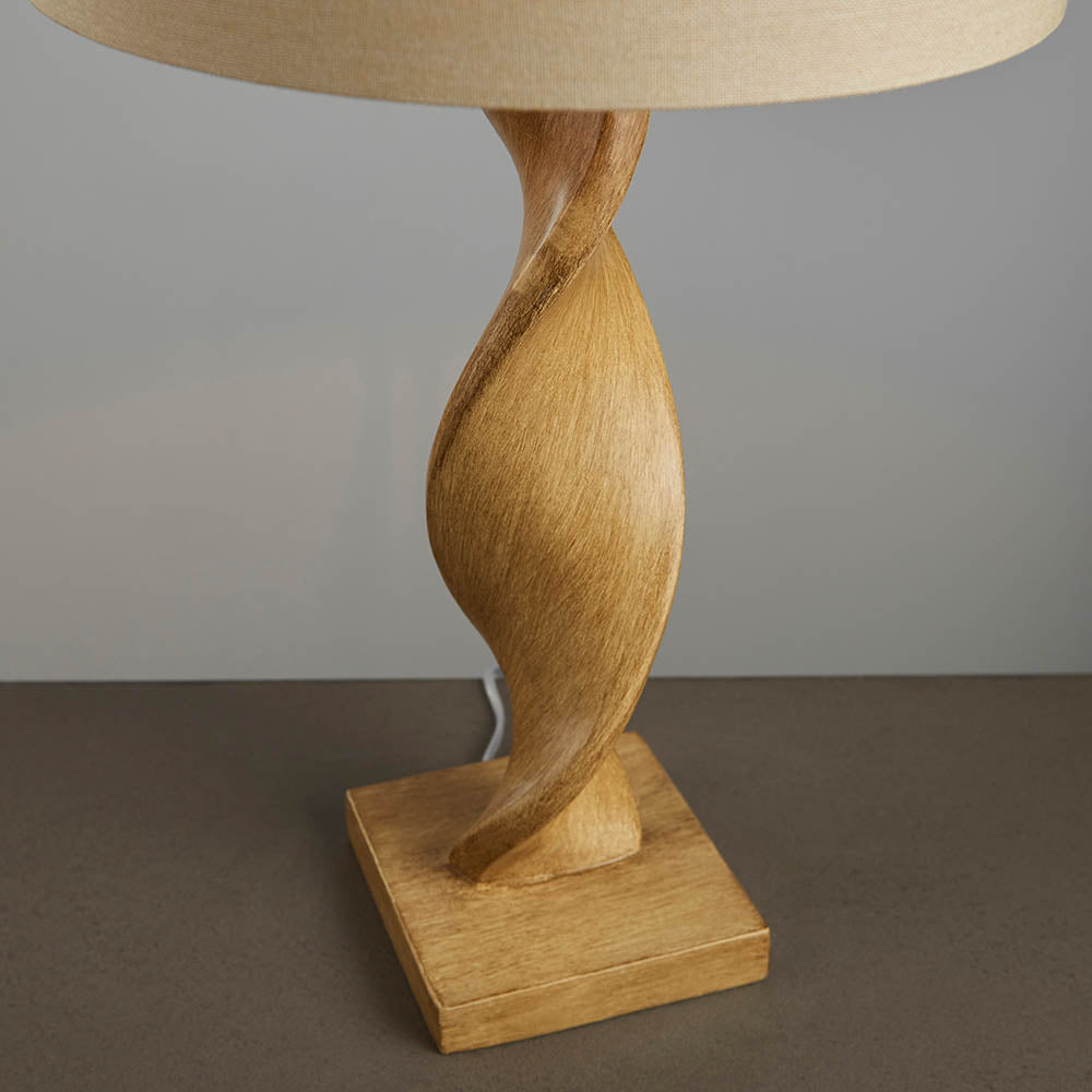Wooden table lamp with a beige lampshade on a neutral background