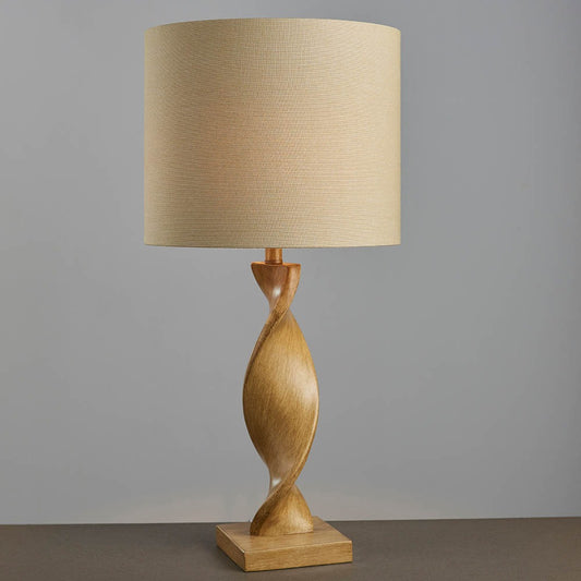 Wooden table lamp with a beige lampshade on a gray background