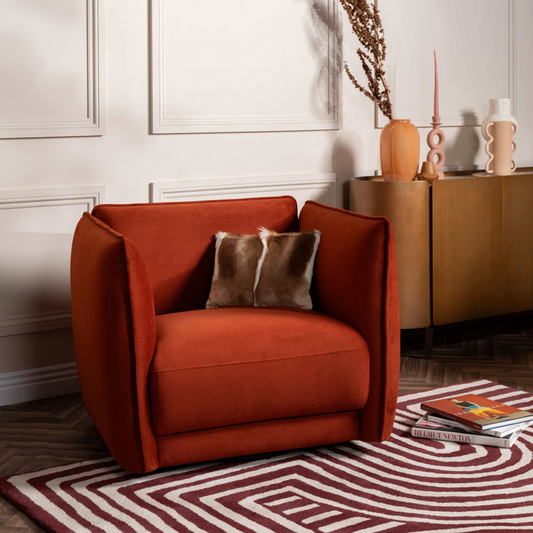 Orange armchair with a pillow in a living room setting