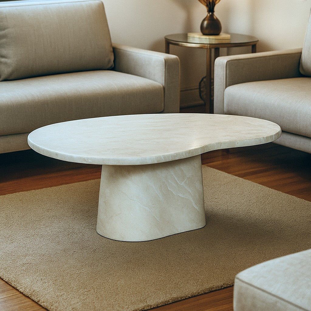 Marble coffee table in a living room setting with beige sofa and rug.