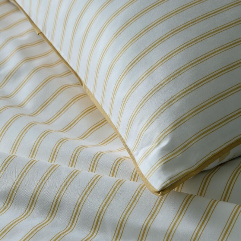 Close-up of striped bedding with yellow lines on a white background