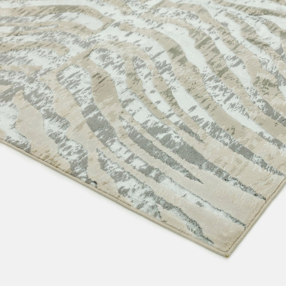 Close-up of a textured area rug with wavy patterns on a light background