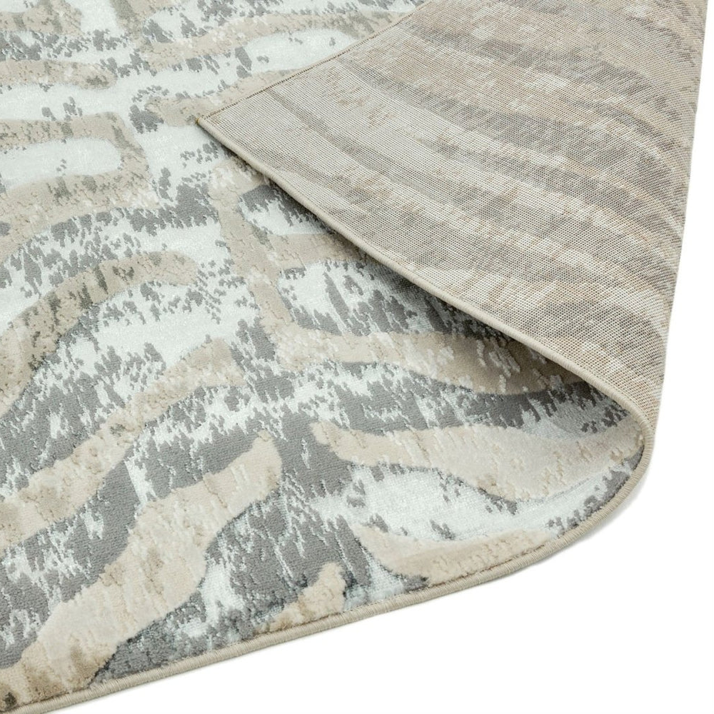 area rug with wavy pattern in neutral colors on a plain background