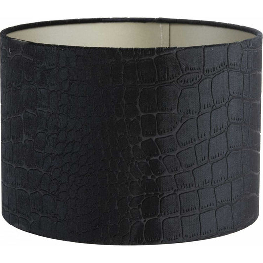 A cylindrical black lampshade with a textured, faux crocodile skin pattern and a light-coloured interior.