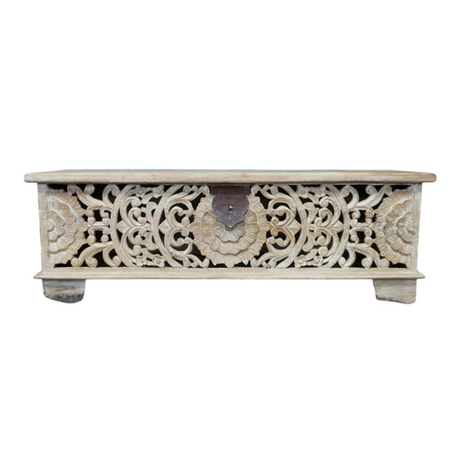 A handcrafted storage bench made from solid mango wood, measuring 135cm wide, 40cm deep, and 46cm high. The bench features a whitewashed finish and intricately carved floral and geometric patterns on its front panel. It includes a lift-up lid revealing a spacious internal compartment, offering both seating and storage solutions. The rustic design and boho craftsmanship make it suitable for various interior styles, including bohemian, farmhouse, and eclectic decors.
