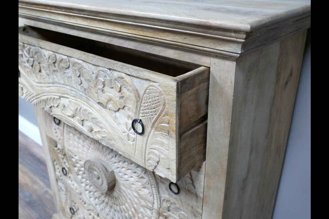 A solid wood chest of drawers measuring 110cm in height, 90cm in width, and 41cm in depth, featuring intricately hand-carved floral and geometric patterns on its drawer fronts. The natural wood finish highlights the detailed craftsmanship, making it a versatile piece suitable for various interior styles, including bohemian, rustic, and moroccan decors.