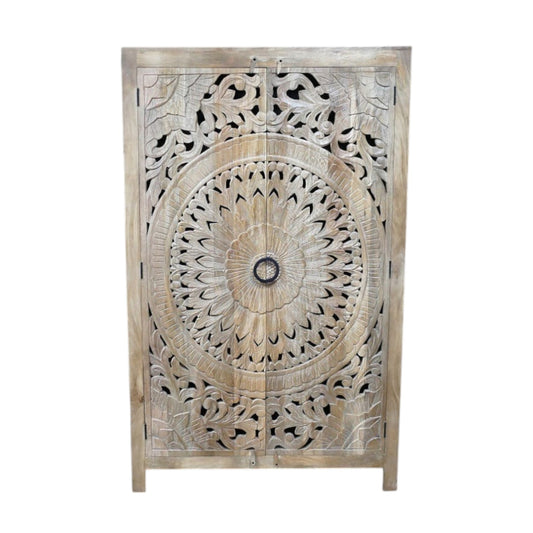 A tall, hand-carved solid wood wardrobe measuring approximately 109 in height, featuring intricate floral and geometric carvings on its doors. The natural wood finish highlights the craftsmanship, making it a statement piece suitable for various interior styles, including rustic, bohemian, and eclectic decor.