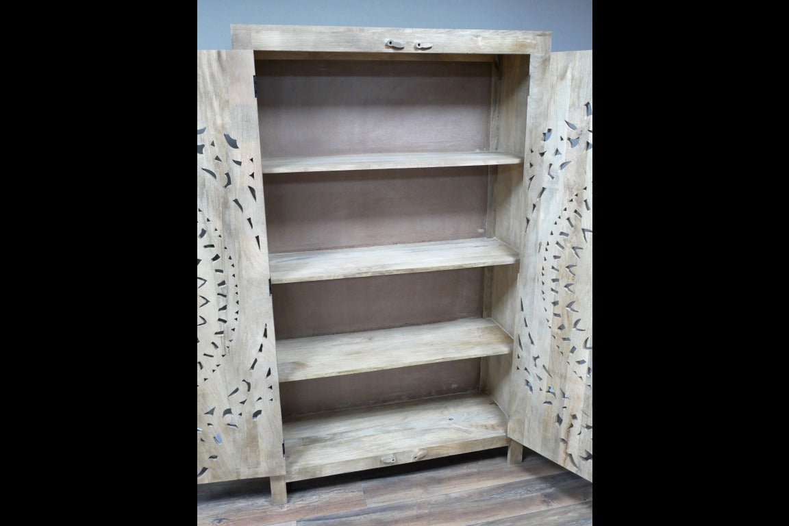 A tall, hand-carved solid wood wardrobe measuring approximately 109 in height, featuring intricate floral and geometric carvings on its doors. The natural wood finish highlights the craftsmanship, making it a statement piece suitable for various interior styles, including rustic, bohemian, and eclectic decor.