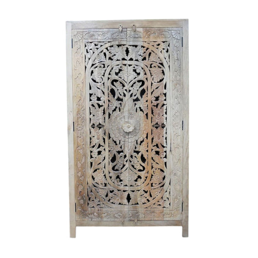 A tall, hand-carved solid mango wood cabinet measuring 180cm in height, 100cm in width, and 40cm in depth. The cabinet features two full-length doors adorned with intricate floral and geometric carvings, reflecting Eastern design influences. Finished in a natural wood tone, this piece offers ample internal storage with shelved compartments, making it both functional and decorative. Suitable for various interior styles, including bohemian, rustic, and eclectic homes.
