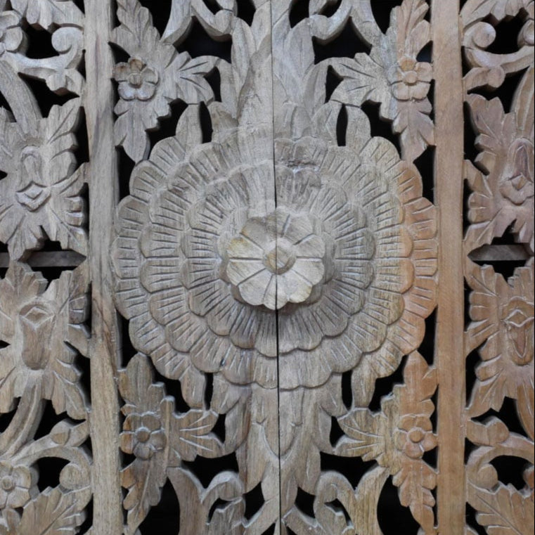 A tall, hand-carved solid mango wood cabinet measuring 180cm in height, 100cm in width, and 40cm in depth. The cabinet features two full-length doors adorned with intricate floral and geometric carvings, reflecting Eastern design influences. Finished in a natural wood tone, this piece offers ample internal storage with shelved compartments, making it both functional and decorative. Suitable for various interior styles, including bohemian, rustic, and eclectic homes.