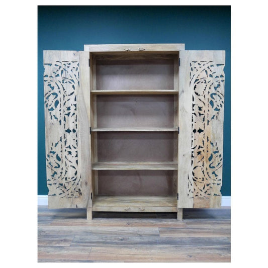 A tall, hand-carved solid mango wood cabinet measuring 180cm in height, 100cm in width, and 40cm in depth. The cabinet features two full-length doors adorned with intricate floral and geometric carvings, reflecting Eastern design influences. Finished in a natural wood tone, this piece offers ample internal storage with shelved compartments, making it both functional and decorative. Suitable for various interior styles, including bohemian, rustic, and eclectic homes.