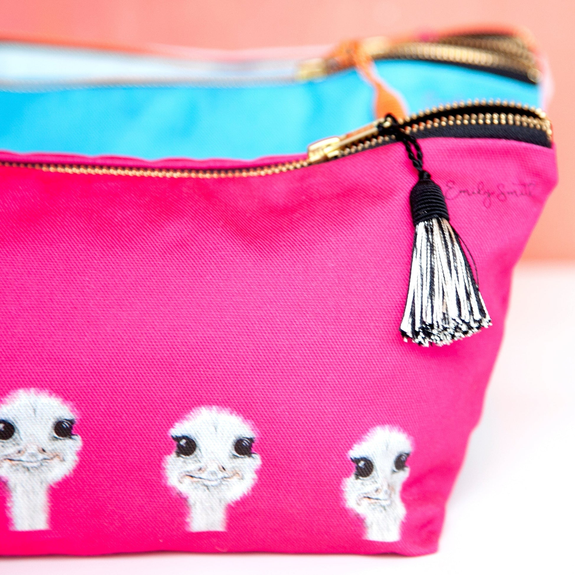 Pink makeup bag with ostrich faces.