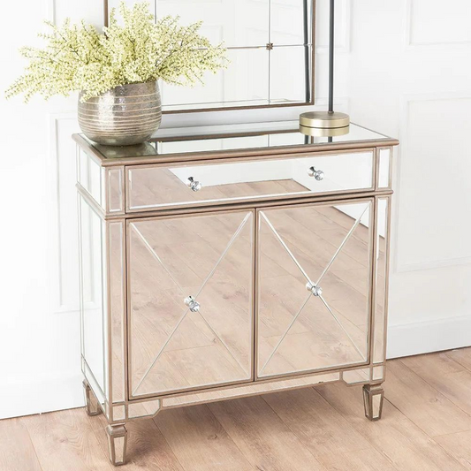 Decorative console table with mirror finish in a room setting.