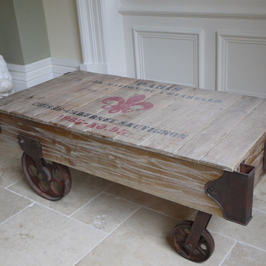 This bold French Railway Style Coffee Table commands attention with its charming, rustic presence. Made of reclaimed wood and adorned with vintage wine crate lettering, it blends tradition with a fun flair. Iron accents and four sturdy wheels enhance its rustic industrial charm, making it a striking centrepiece that transforms any living room into a stylish statement space!
