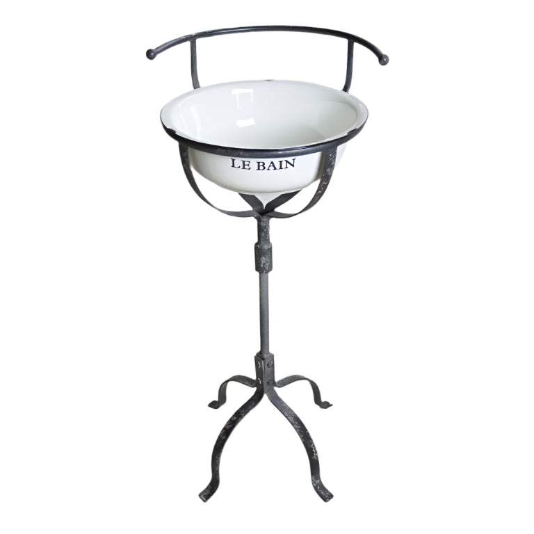 Make a striking statement with the French Style Wash Basin, where vintage elegance meets rustic design. The white enamel basin, artfully aged for a weathered look with a charming 'Le Bain' design, rests on a sturdy rustic iron stand that exudes charm. Elevate your space with this fearless blend of classic style and rebellious spirit, ideal for French inspired, shabby chic home decor styles.