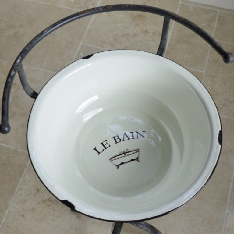 Make a striking statement with the French Style Wash Basin, where vintage elegance meets rustic design. The white enamel basin, artfully aged for a weathered look with a charming 'Le Bain' design, rests on a sturdy rustic iron stand that exudes charm. Elevate your space with this fearless blend of classic style and rebellious spirit, ideal for French inspired, shabby chic home decor styles.