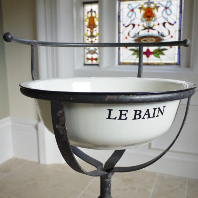 Make a striking statement with the French Style Wash Basin, where vintage elegance meets rustic design. The white enamel basin, artfully aged for a weathered look with a charming 'Le Bain' design, rests on a sturdy rustic iron stand that exudes charm. Elevate your space with this fearless blend of classic style and rebellious spirit, ideal for French inspired, shabby chic home decor styles.