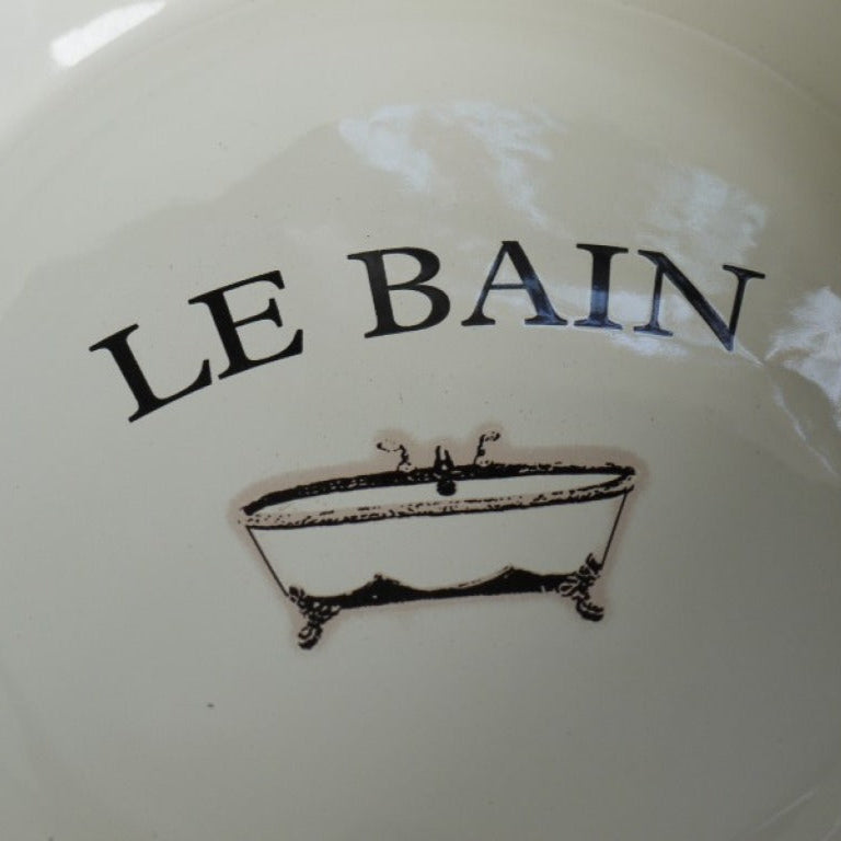 Make a striking statement with the French Style Wash Basin, where vintage elegance meets rustic design. The white enamel basin, artfully aged for a weathered look with a charming 'Le Bain' design, rests on a sturdy rustic iron stand that exudes charm. Elevate your space with this fearless blend of classic style and rebellious spirit, ideal for French inspired, shabby chic home decor styles.