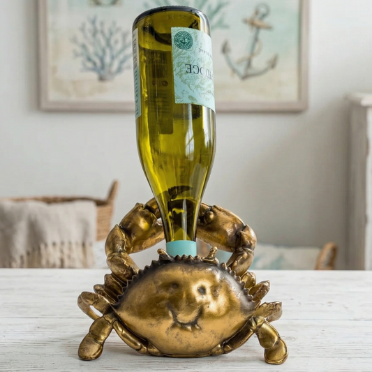 Gold crab-shaped bottle holder with a wine bottle on a table