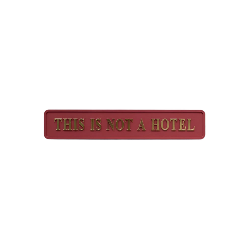 Red and Gold 'This Is Not A Hotel' Sign
