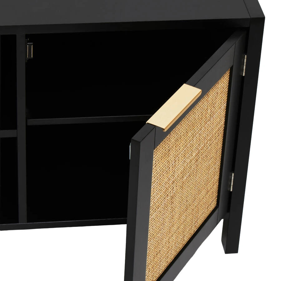 A close-up of a black cabinet with one door swung open, showing a natural woven cane panel on the door and a light wood handle.