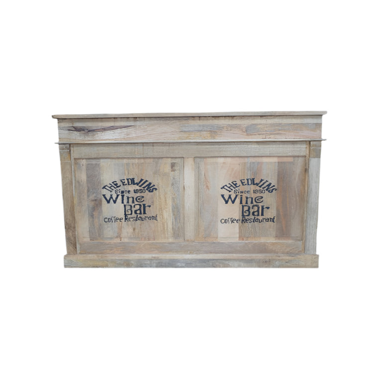 Elevate your entertaining space with this daring Rustic Mango Wood Bar Cabinet! Crafted from solid mango wood, its boho rustic charm is enhanced textured, natural details and bold black stamped accents that bring a unique edge. Featuring two spacious drawers, open shelves, and built-in wine racks, it offers generous storage to showcase your finest spirits and glassware. Ideal for rustic, boho, coastal interiors!