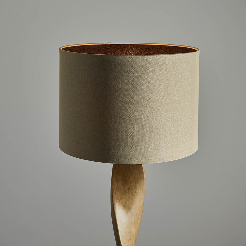 Lamp with a beige shade and wooden base on a gray background