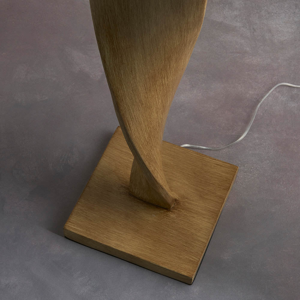 Wooden lamp with a square base on a gray surface