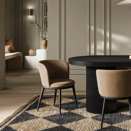 Modern dining room with a black round table and beige chairs.