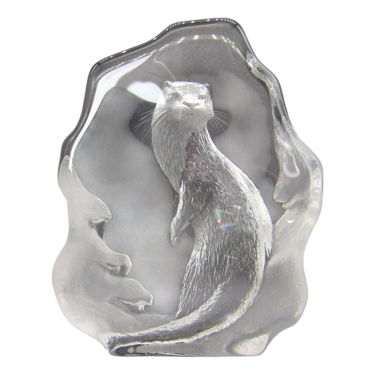Clear crystal sculpture paperweight of an otter on a white background