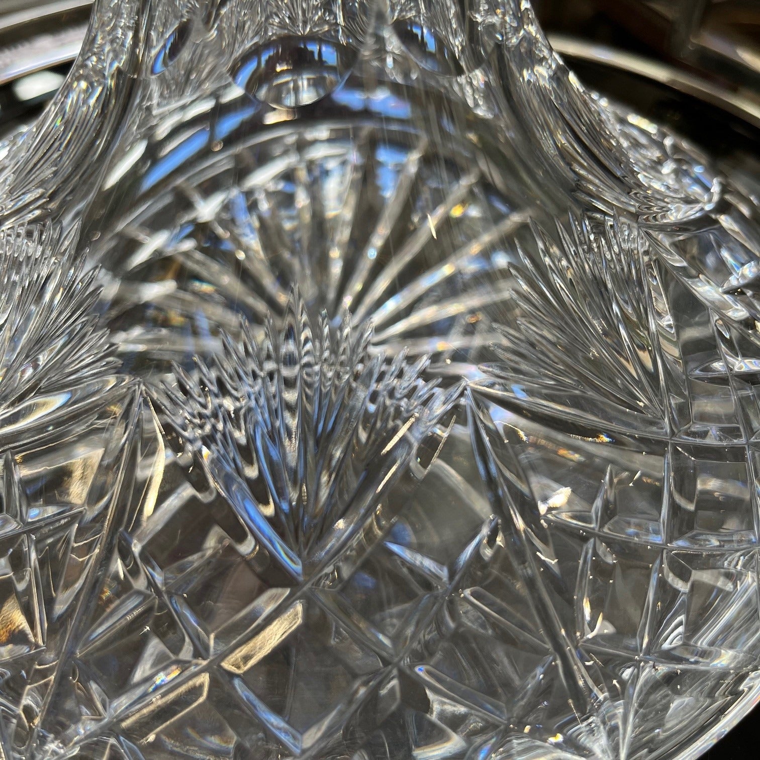Close-up of a crystal decanter with intricate cut patterns